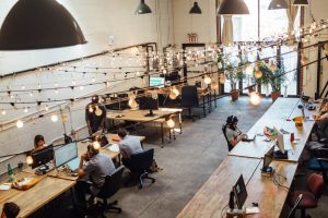 bunch of people working freelance jobs in a cafe style coworking space