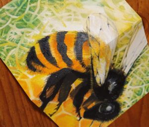 A bee is on a card it is by Lynore Avery to signify freelance activism