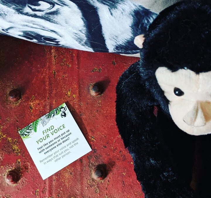 A toy monkey from the freelance jungle events sits on a red spray painted steamer trunk with a card that reads find your voice to signify marketing your freelance business