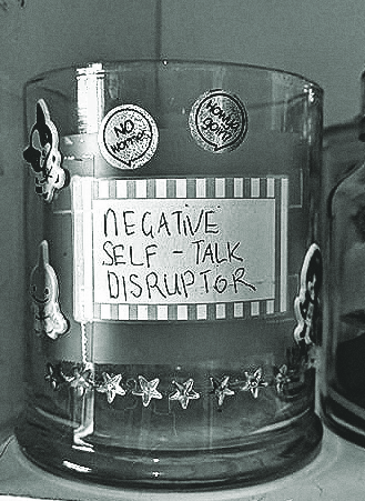 A negative self talk disruptor is one of the pandemic survival tips for freelancers mentioned. It is a big candle jar with a label on it, covered in stickers.