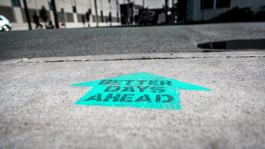 a spray painted sign reads "better days ahead" on the sidewalk. in this instance, we're referring to better days through freelance fulltime