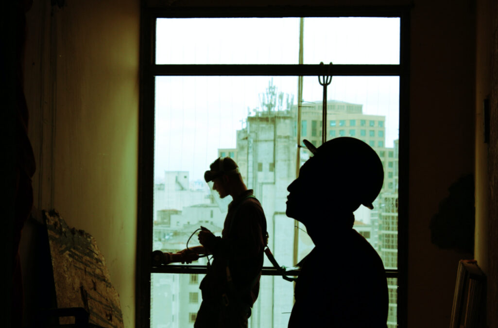 maintenance workers work on a building