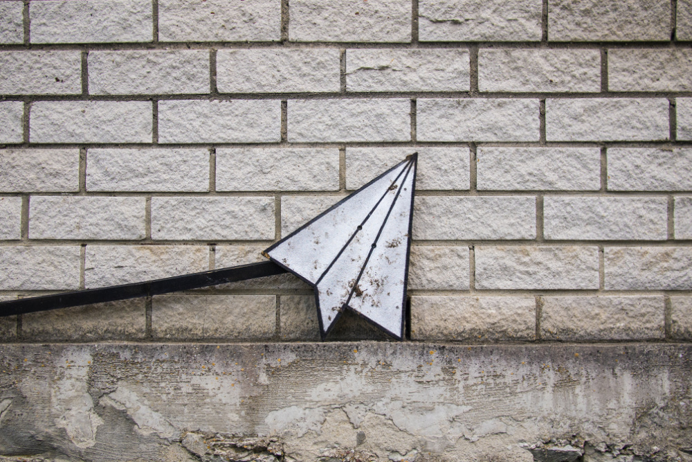 a paper airplane on a brick wall to signify freelance email management