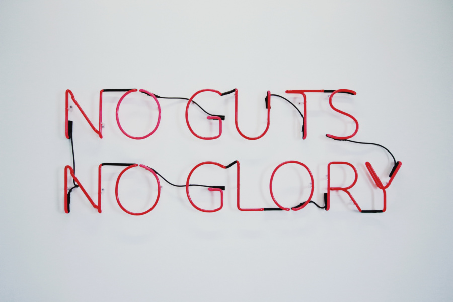 a neon sign that reads no guts no glory