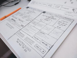 A freelance plan is sketched out on a piece of paper