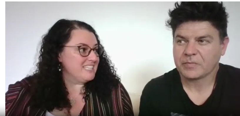 a woman with glasses and brown curly hair and a man with dark hair talk about chatgpt