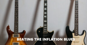 beating the inflation blues is written across three guitars